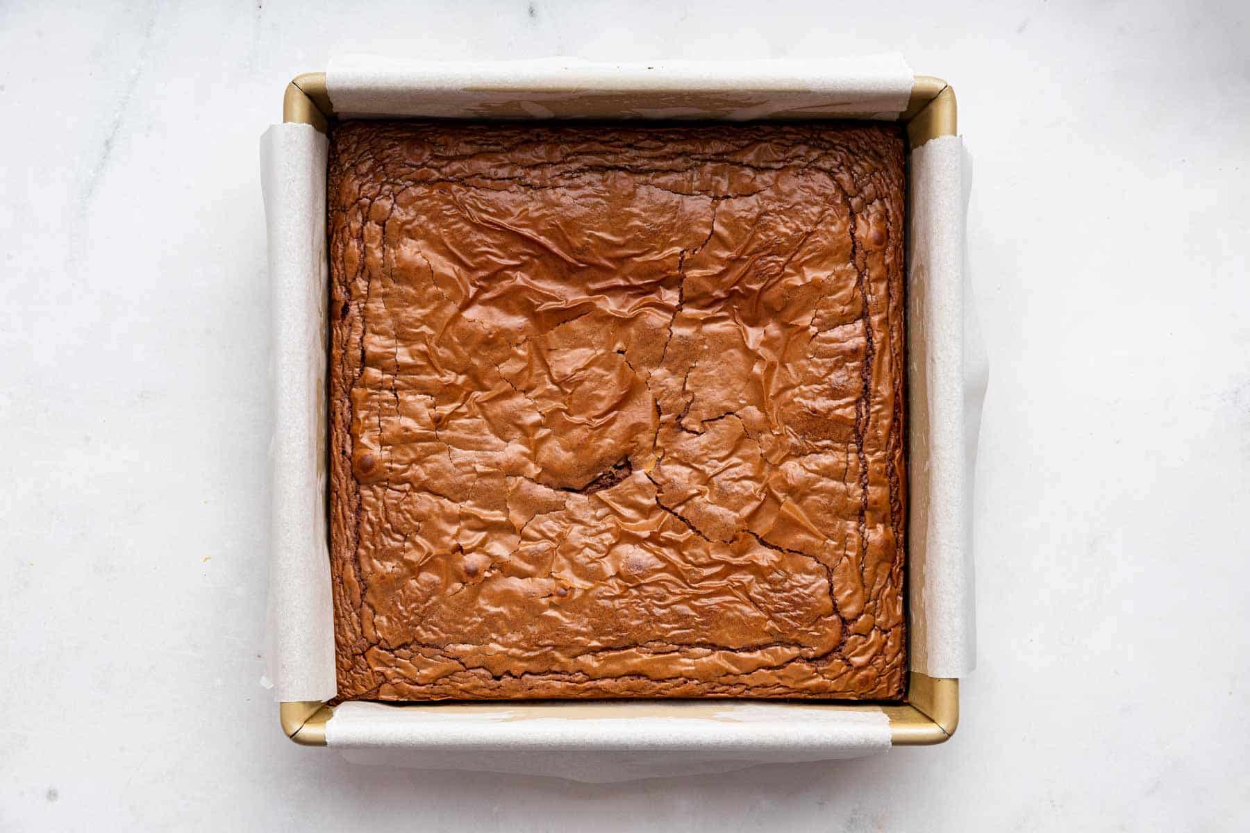 Freshly baked 3 ingredient brownies in a square pan.