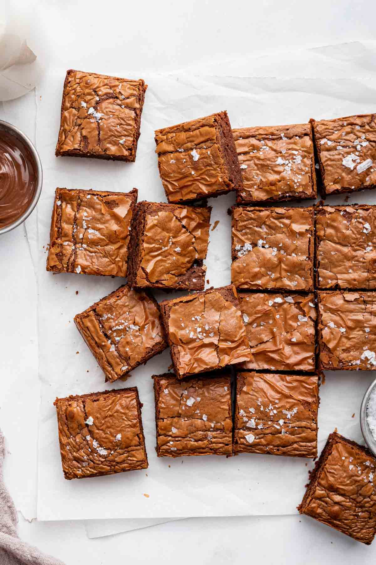 Overhead shot of chocolate dessert squares sprinkled with salt.
