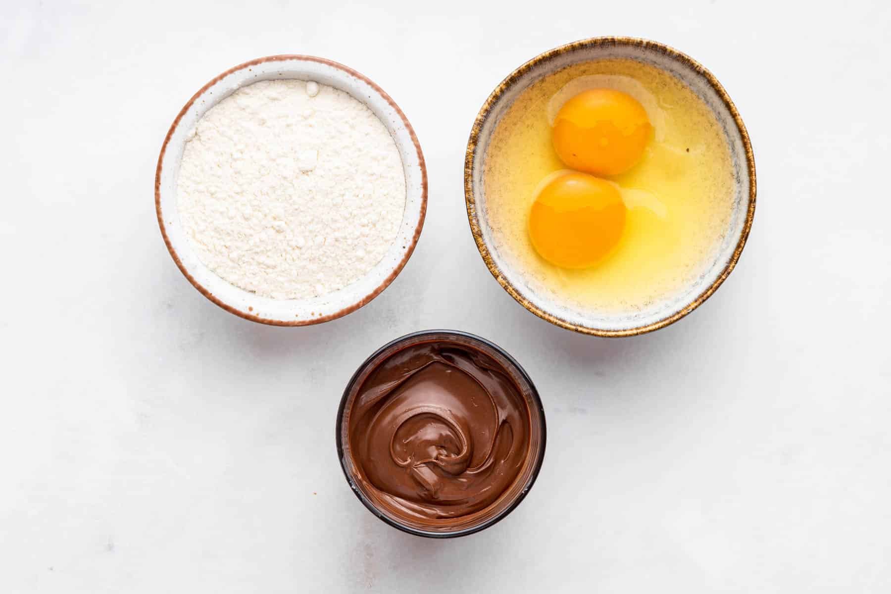 Bowl of flour, eggs, and nutella.