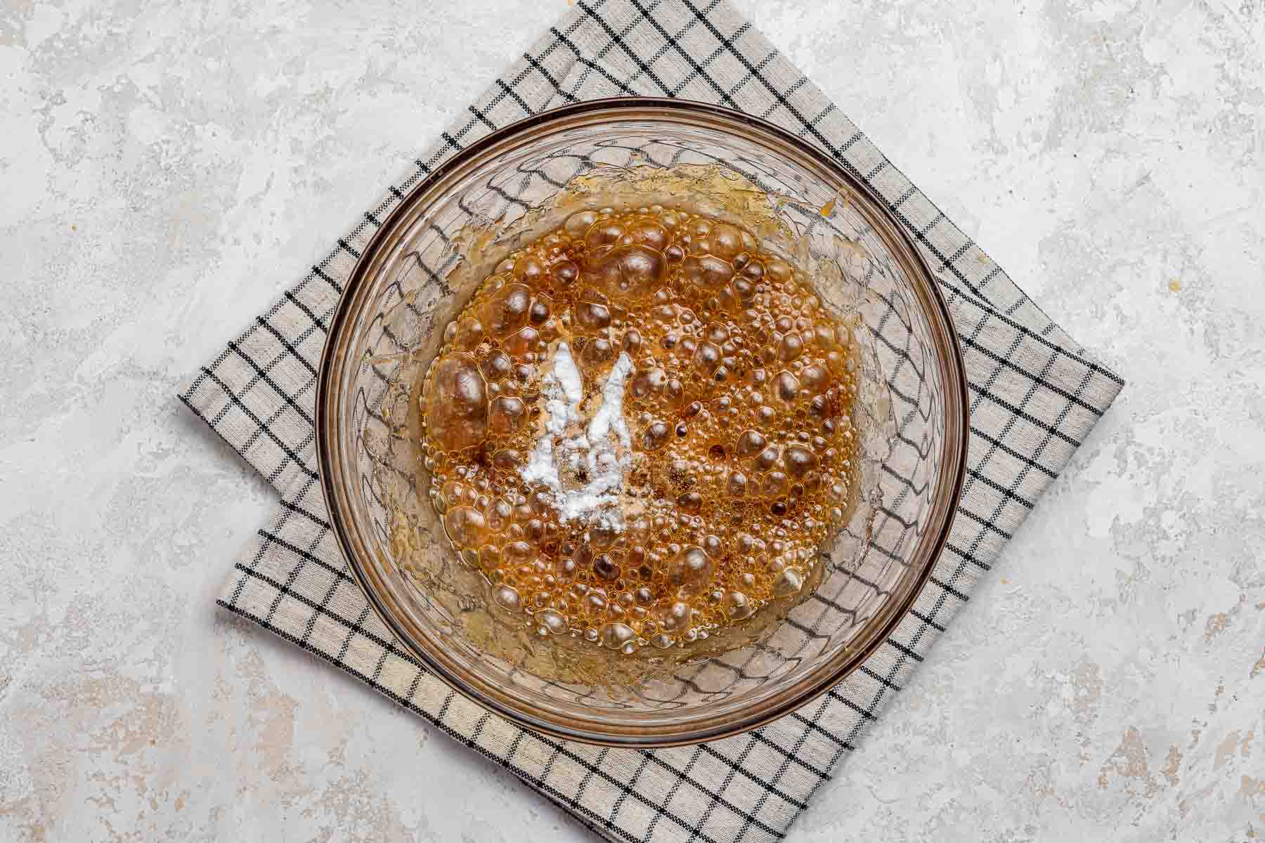 Foaming almond brittle with baking soda.