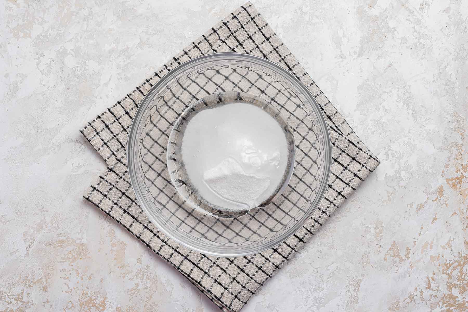 Corn syrup and sugar in clear glass bowl.