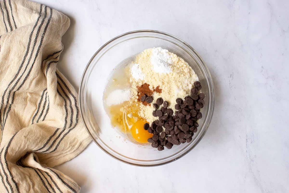 Ingredients for almond flour banana muffins in a bowl.