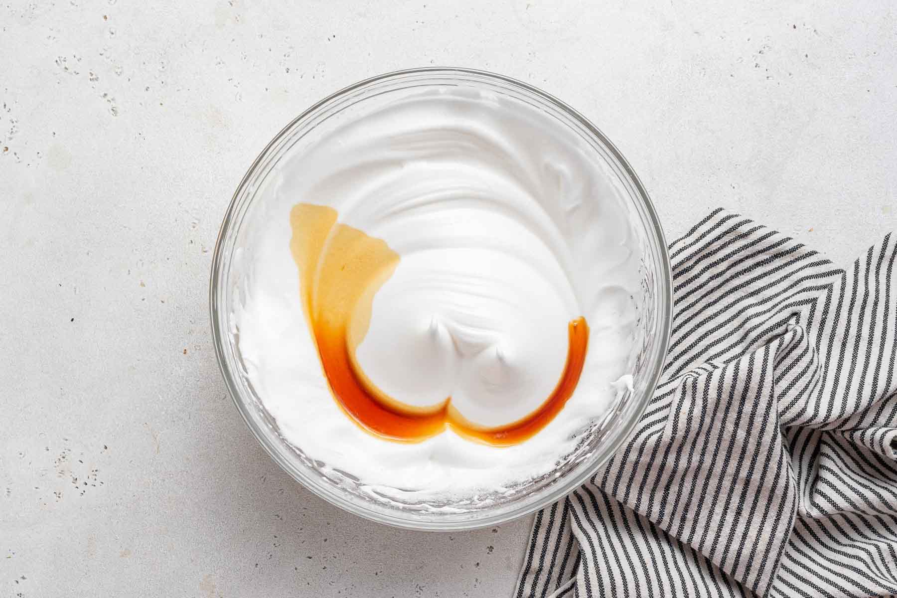 Vanilla extract over beaten egg whites.