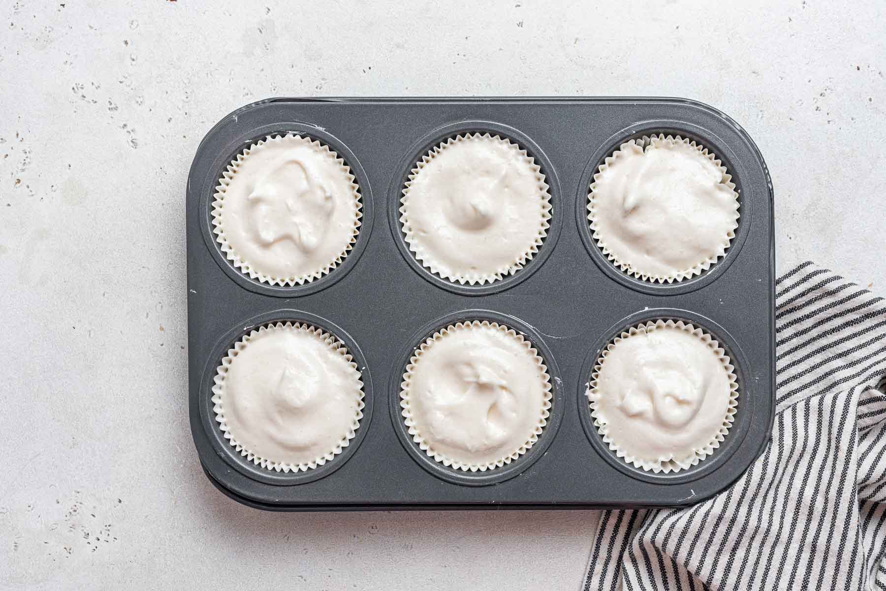 Raw angel food cupcake batter in pan.