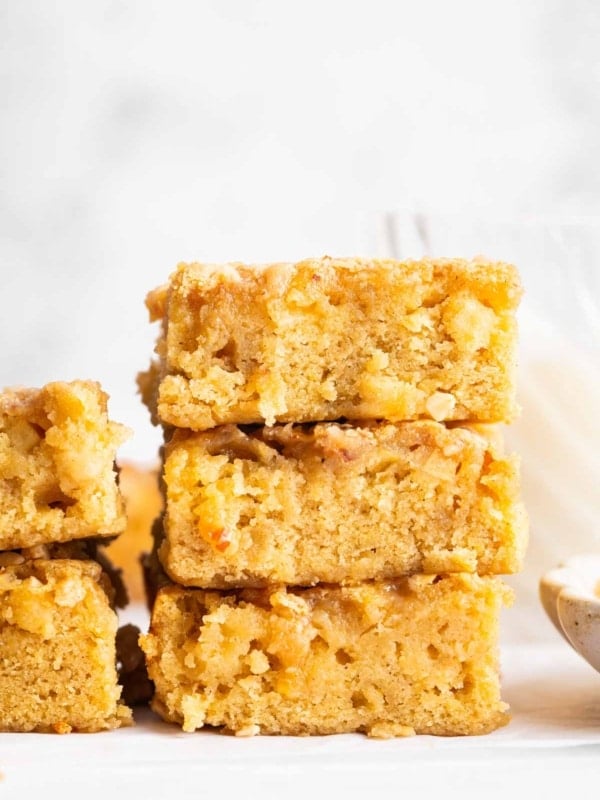 A stack of apple blondies with toffee bits on top.