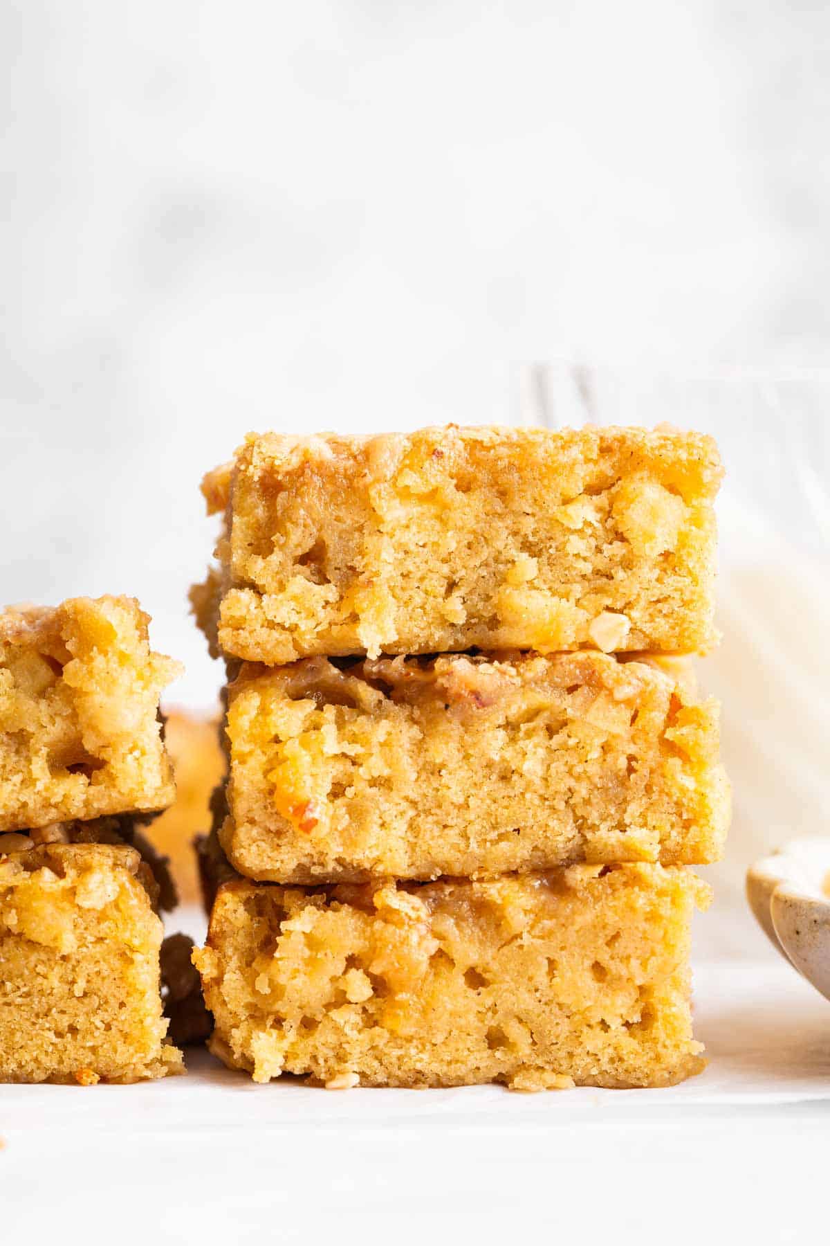 DessertForTwoAppleToffeeBlondies2 Three apple blondies stacked on top of each other.