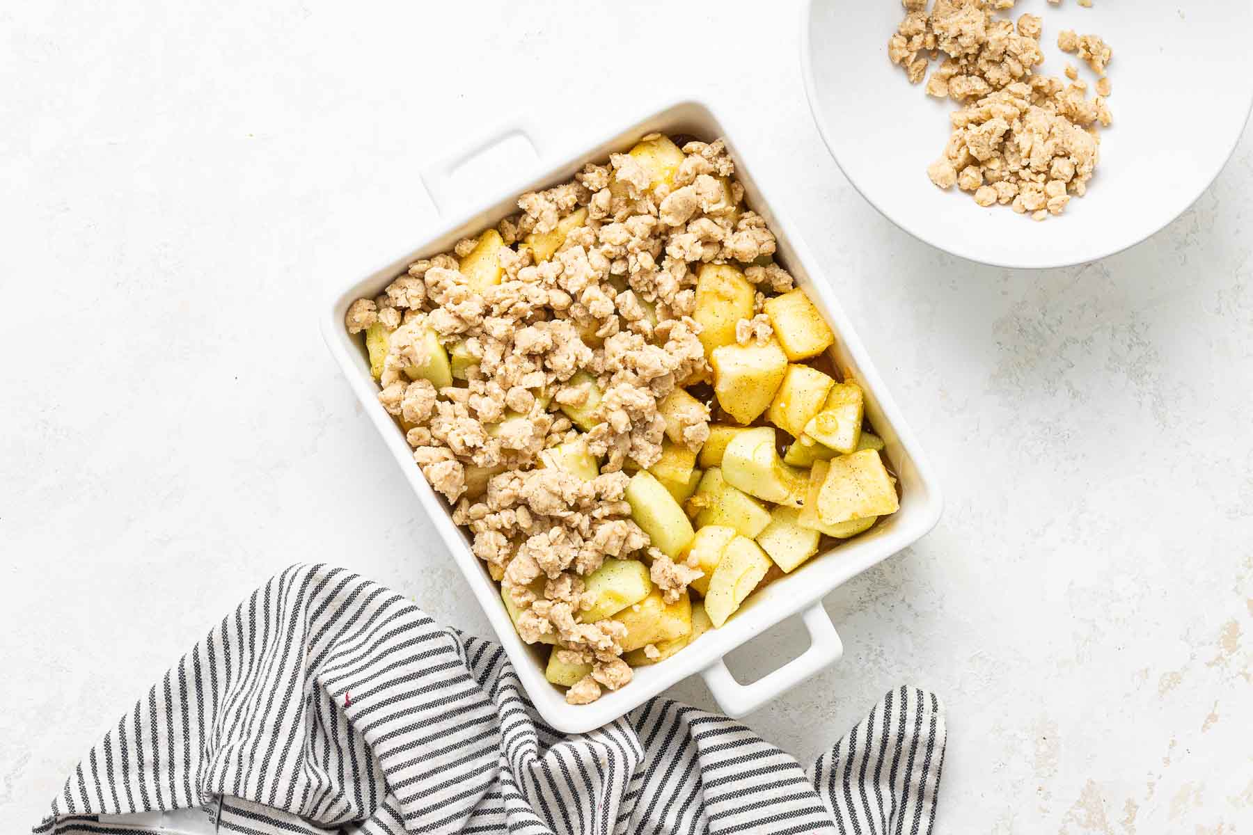 Raw apple crisp with topping before being baked.