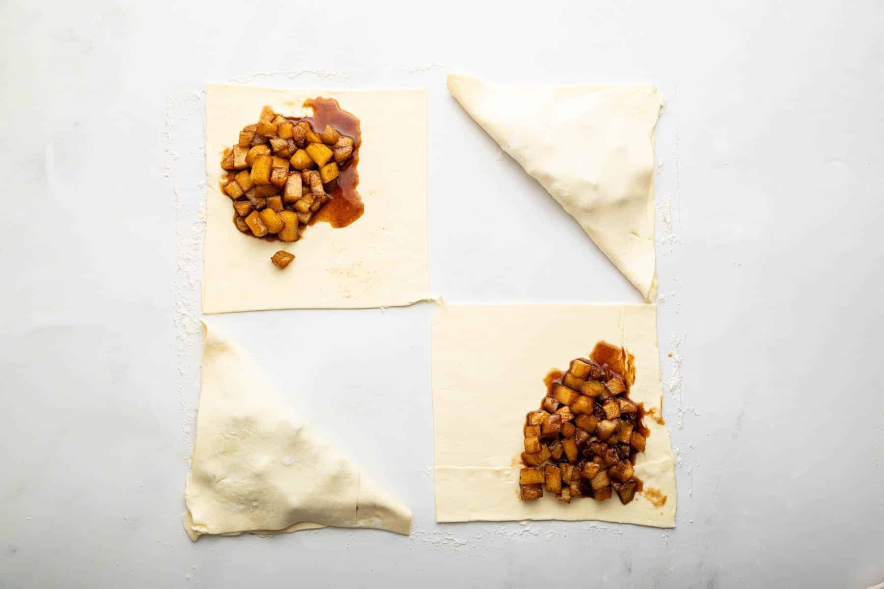 Two triangles and two squares of fruit on pastry.