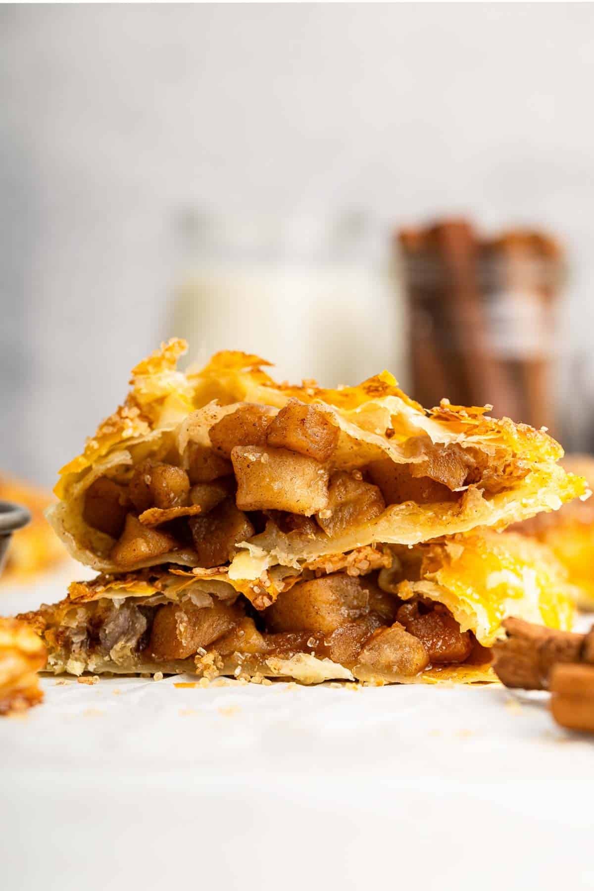 Apple turnover cut in half to show apple filling inside.