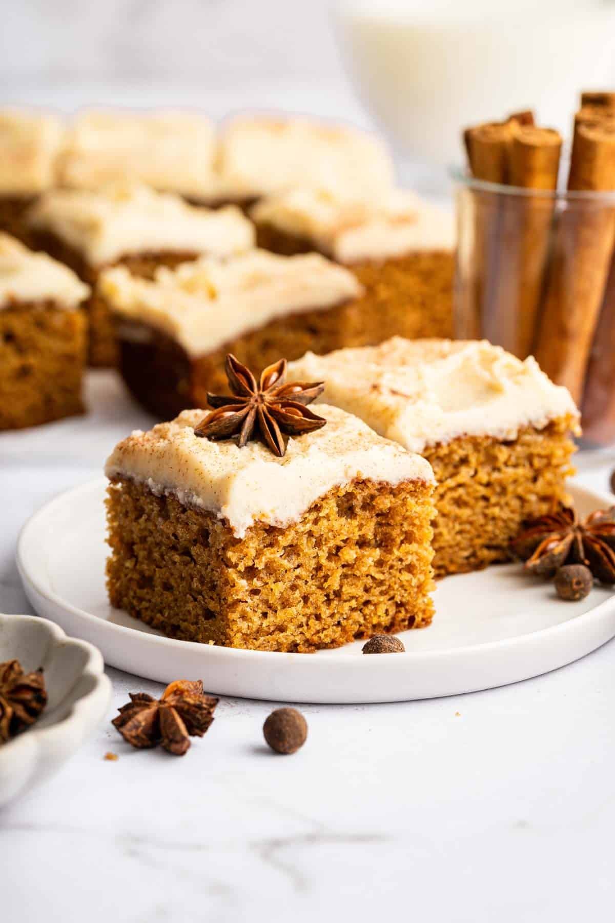 Two slices of applesauce cake on small place garnished with star anise.