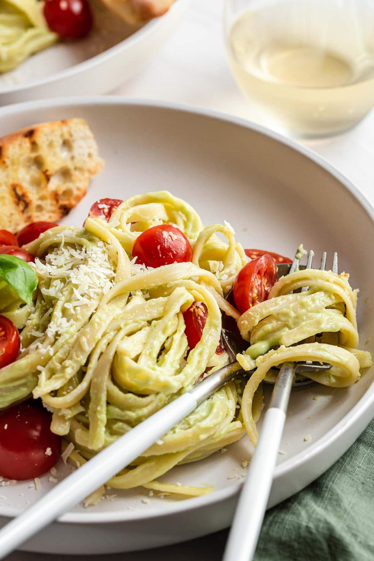 Fork in pasta noodles on plate.