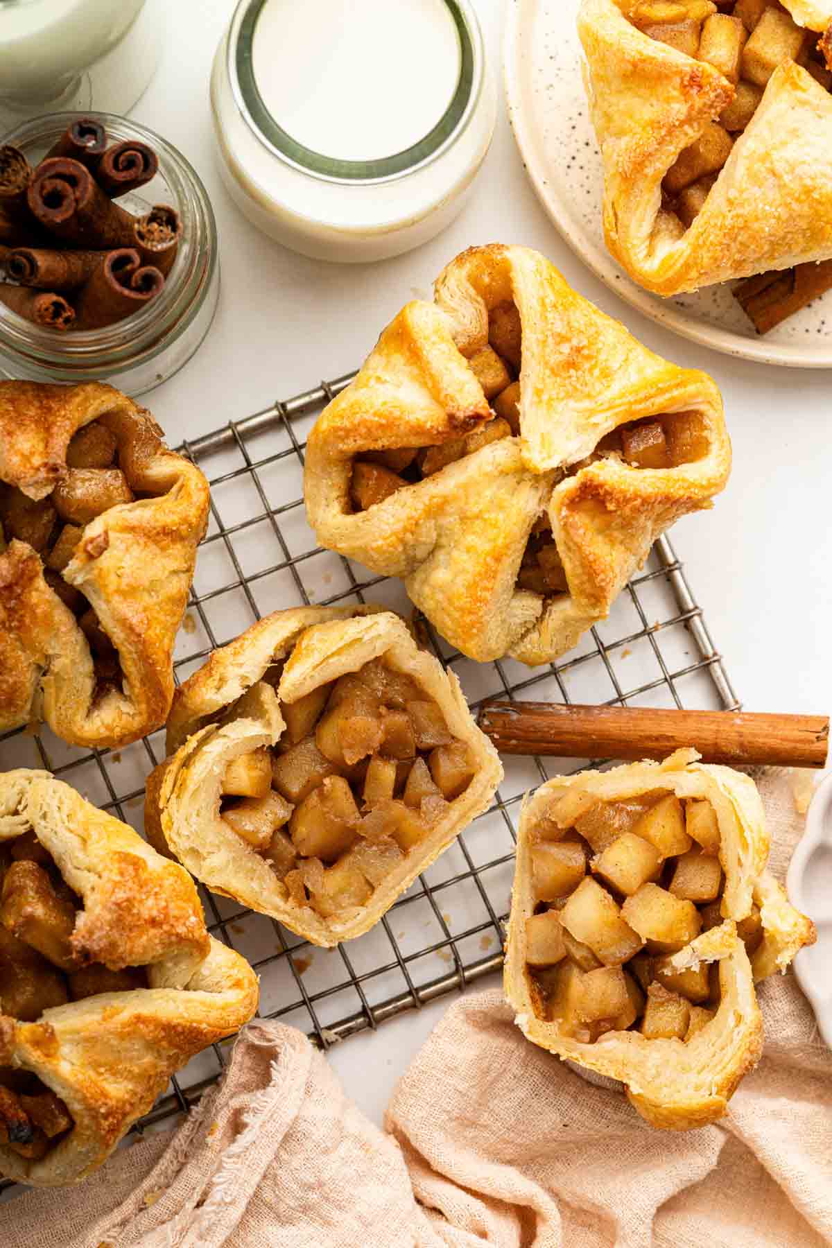 Mini apple croissants on a wire cooling rack.