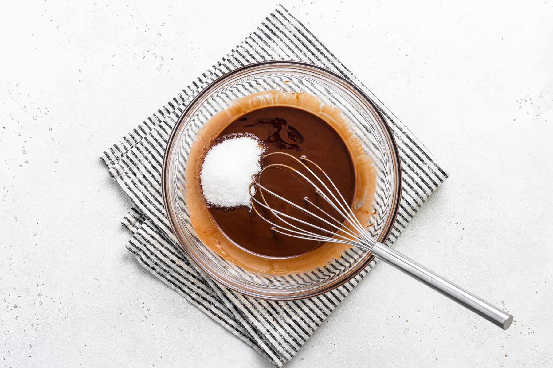 Sugar whisking into melted chocolate.