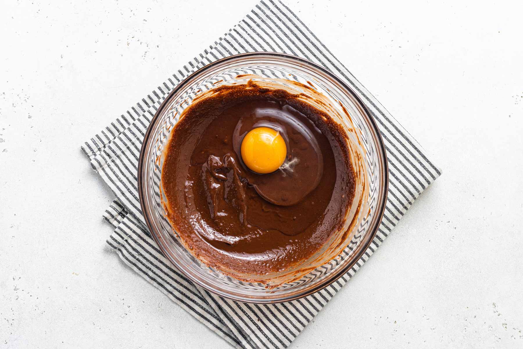 Egg mixing into chocolate batter.