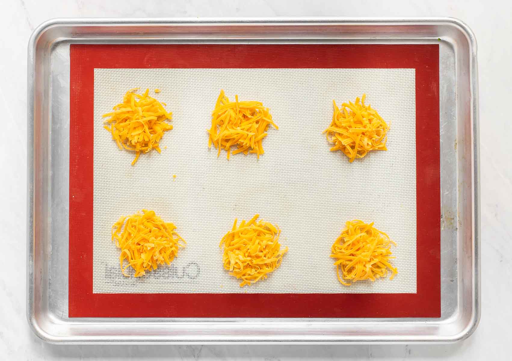 Grated cheese on silicone mat.