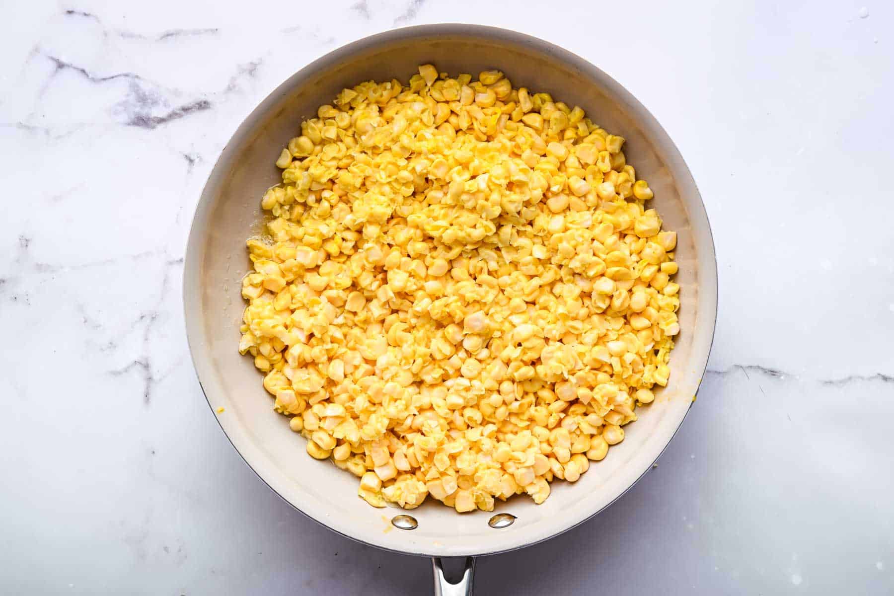 Raw veggies in skillet about to be cooked.