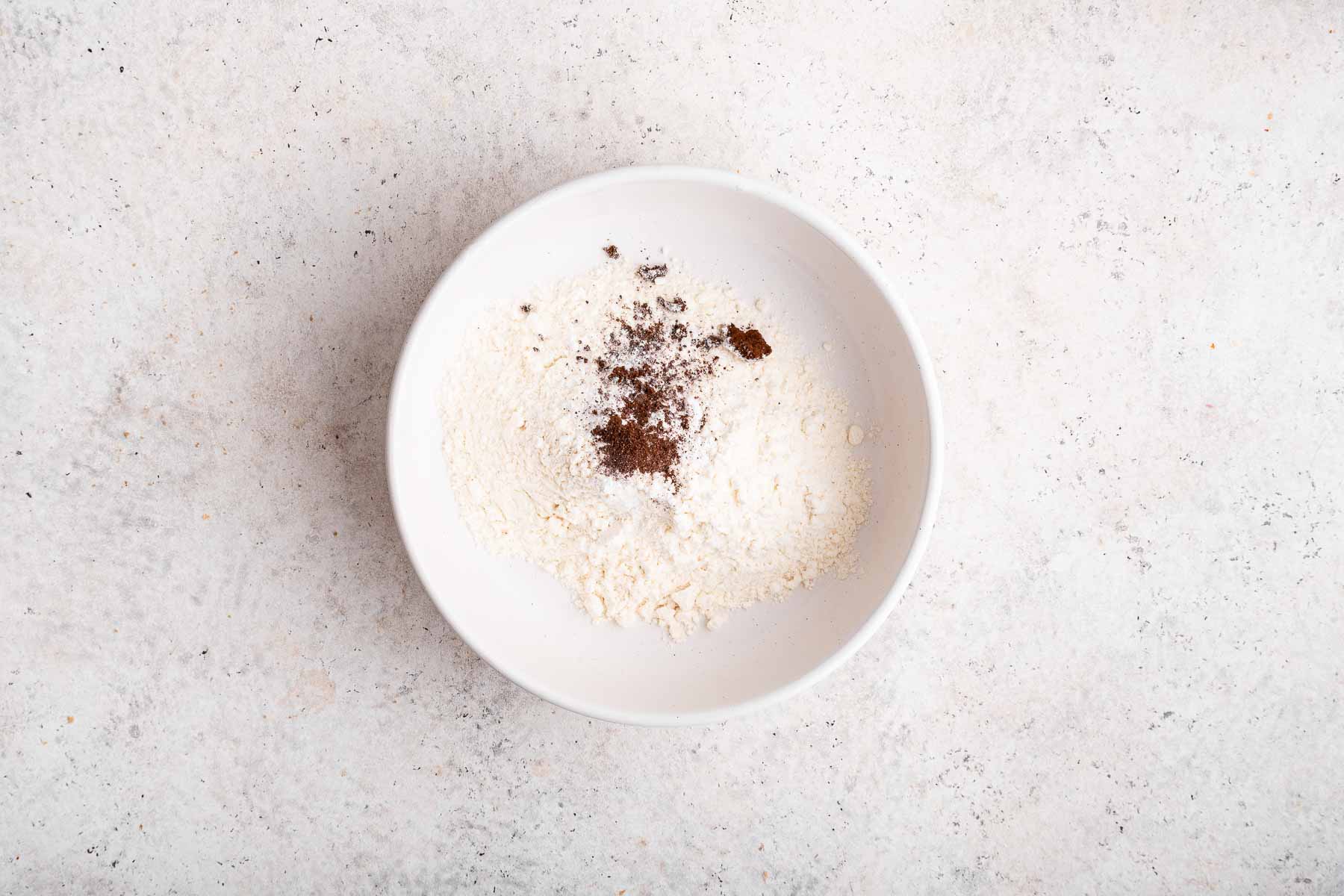 Flour with espresso powder sprinkled on top.