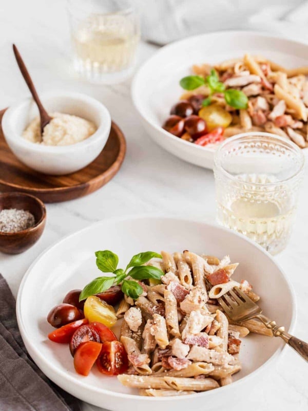 two bowls with chicken and creamy pasta