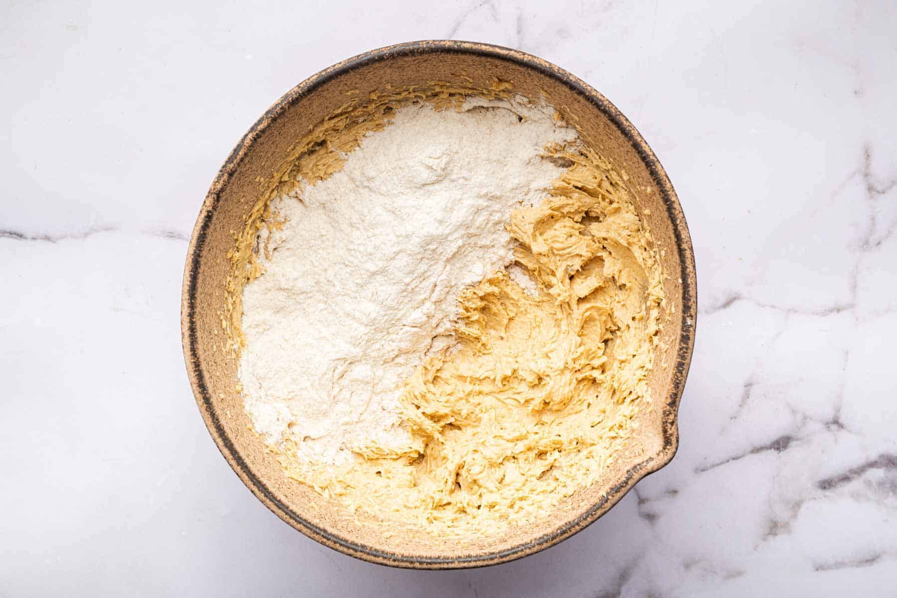 Yellow batter with white flour sprinkled on top.