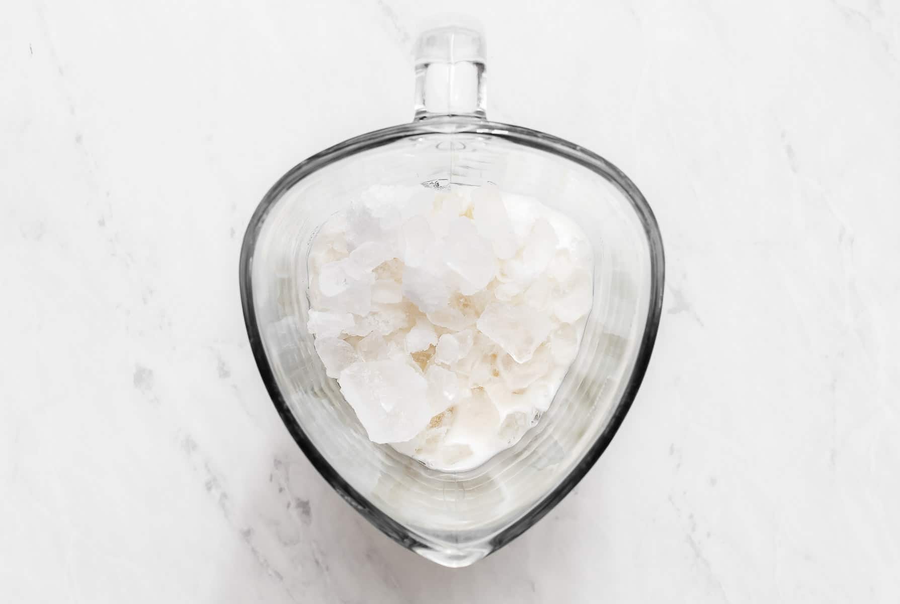 Milk and ice in a blender.