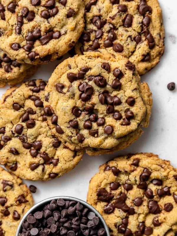 Chocolate chipper cookies on white cutting board.
