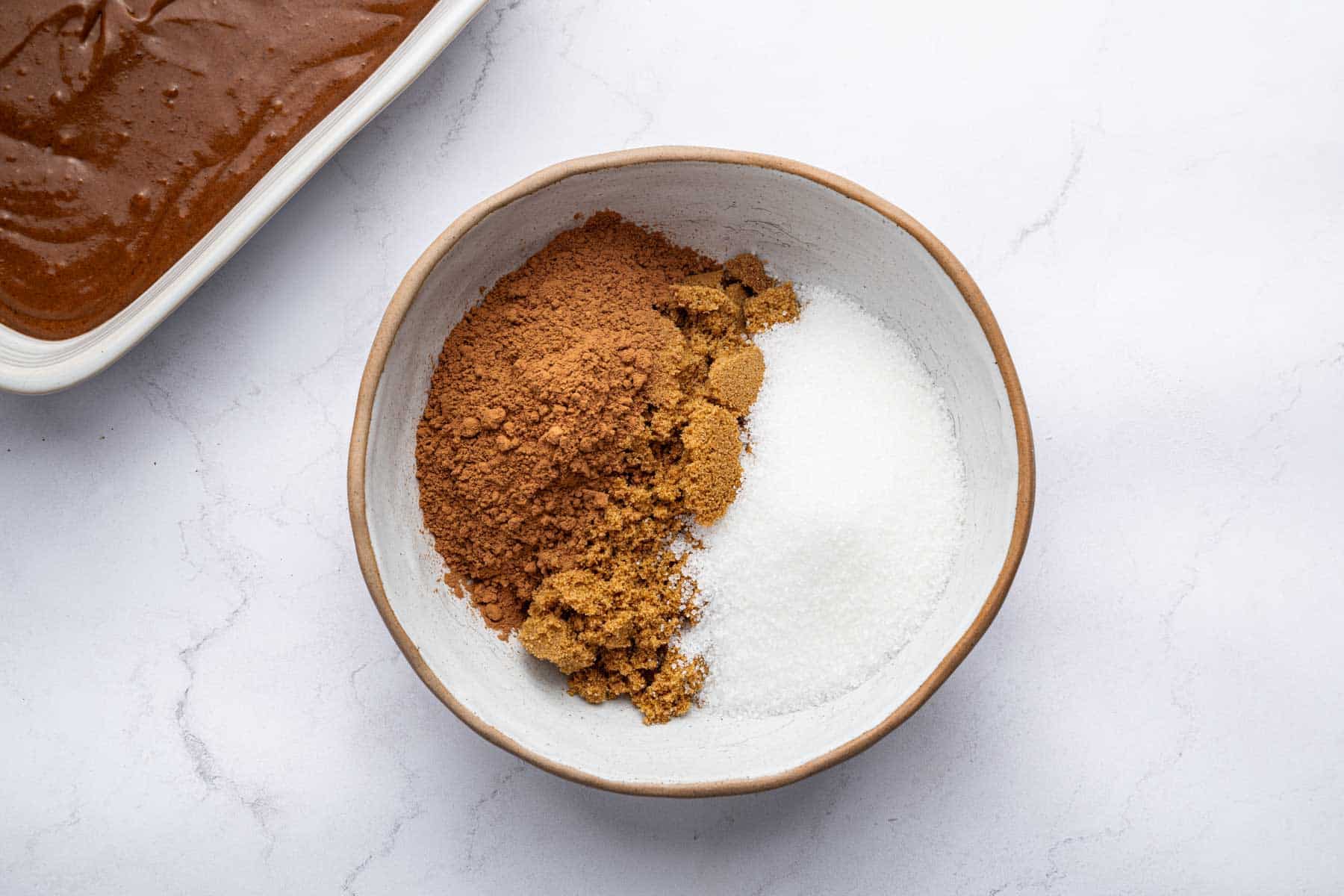 Small white bowl with granulated sugar, brown sugar and cocoa powder only.