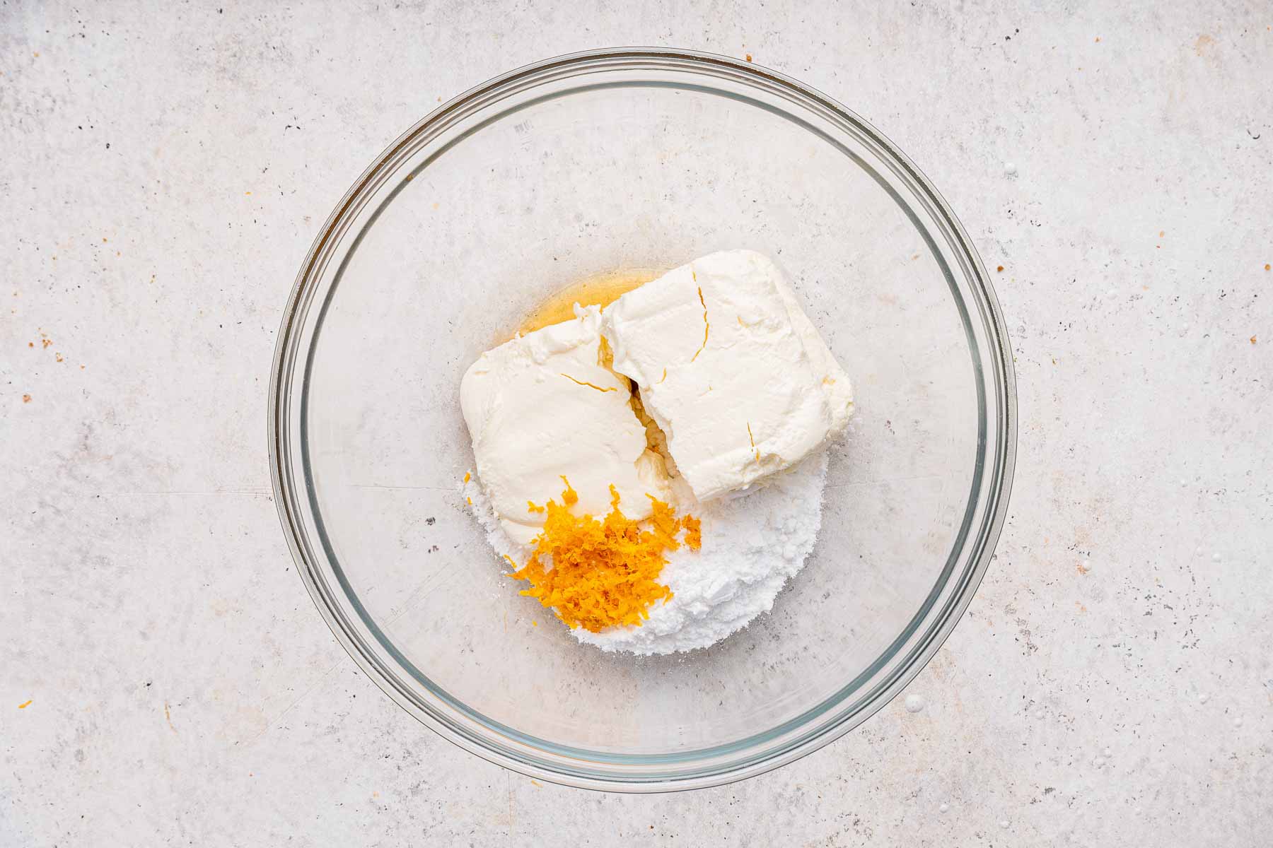 Bowl of cream cheese, sugar rand orange zest.