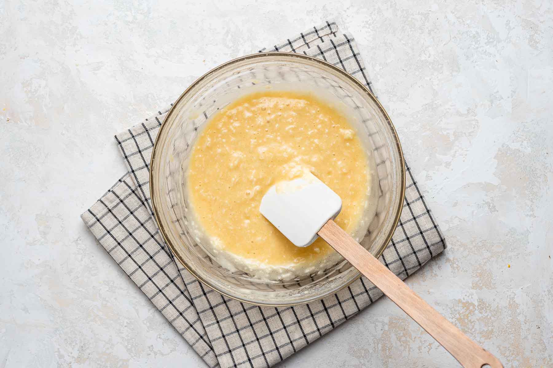 Coconut cupcake batter in clear bowl.