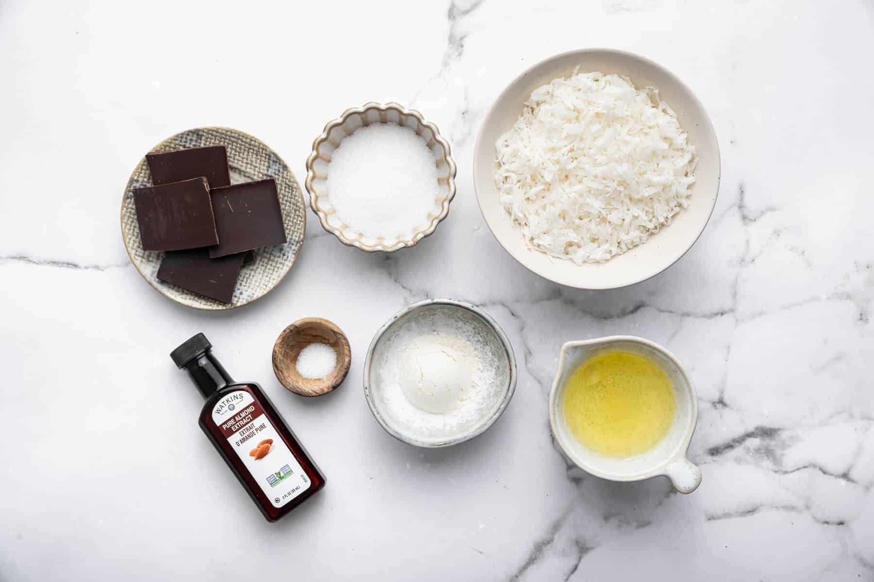 Bowls of flakes, egg white, chopped chocolate, flour and sugar.