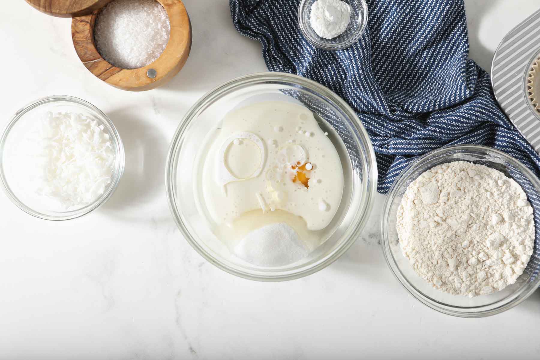 Dissolving coconut oil and coconut milk together in glass bowl.