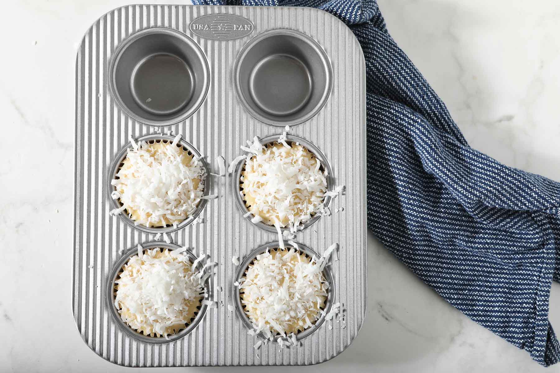 Shredded coconut on top of muffins, before baking.