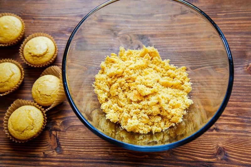 Crumbled cornbread in a glass bowl.