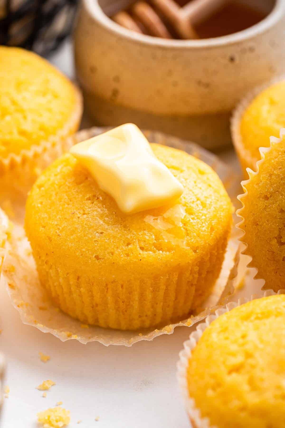 Yellow dessert with a pat of butter on top.