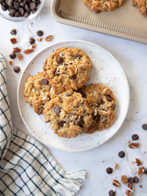 Plate with cowboy cookies, dish towel, and chocolate chips.