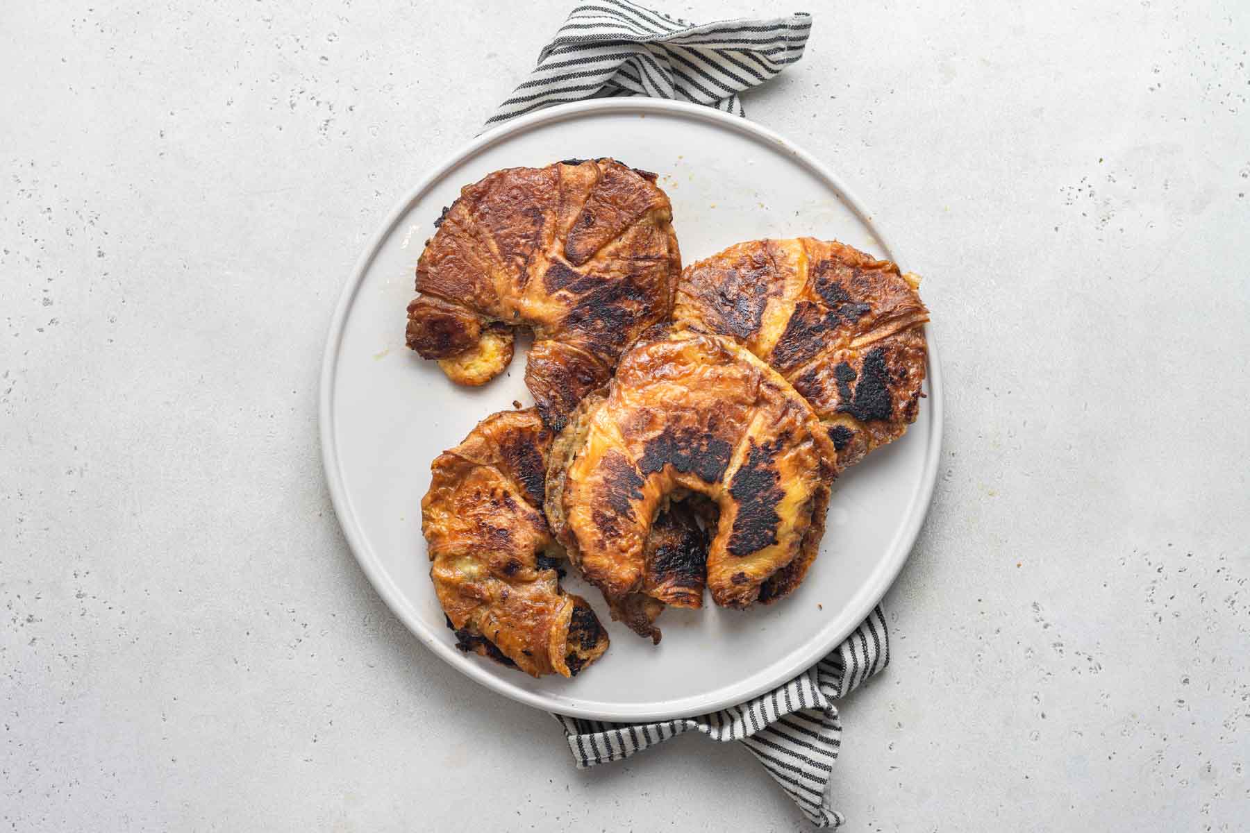 Making French toast with croissants.