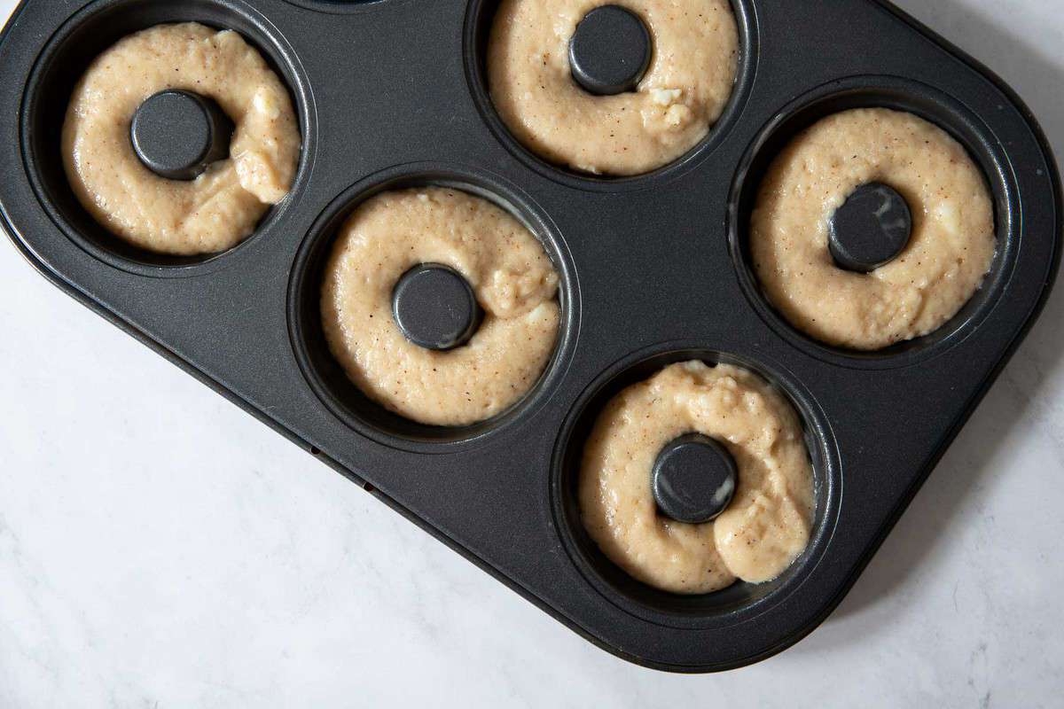 Raw donut batter in donut pan.
