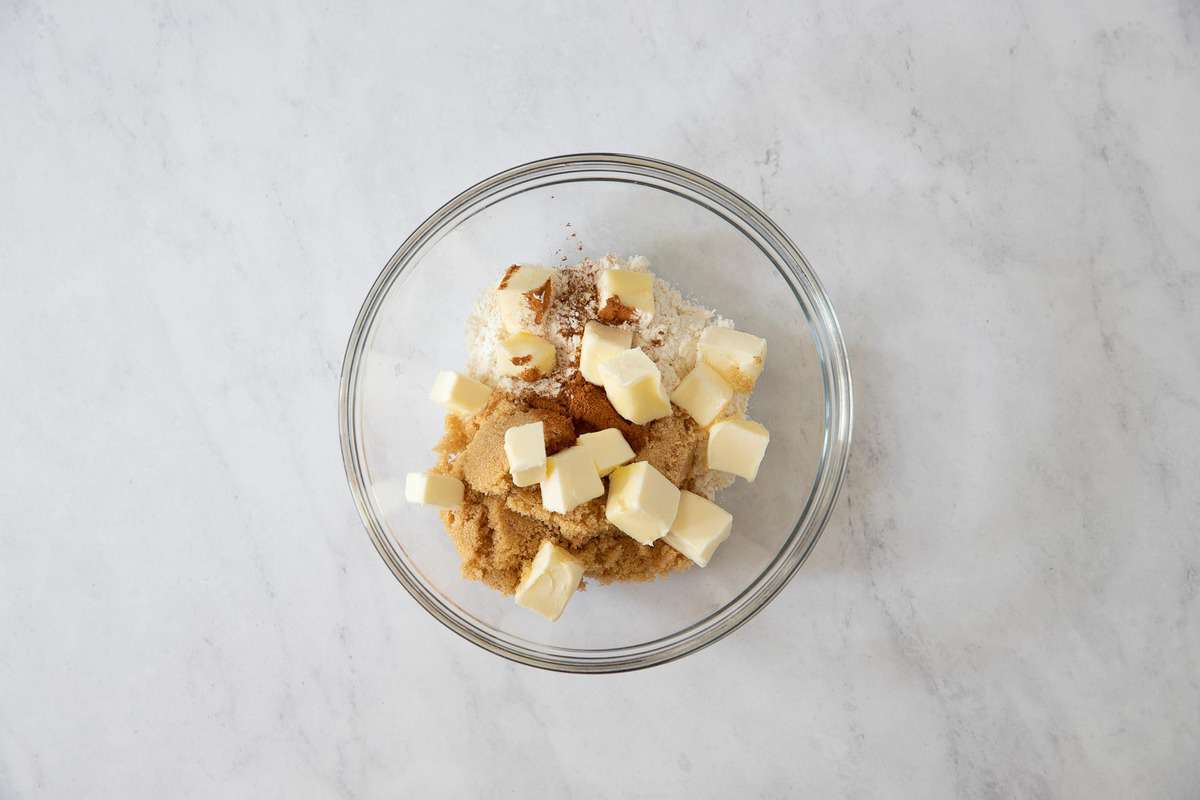 Clear bowl with butter cubes and brown sugar.