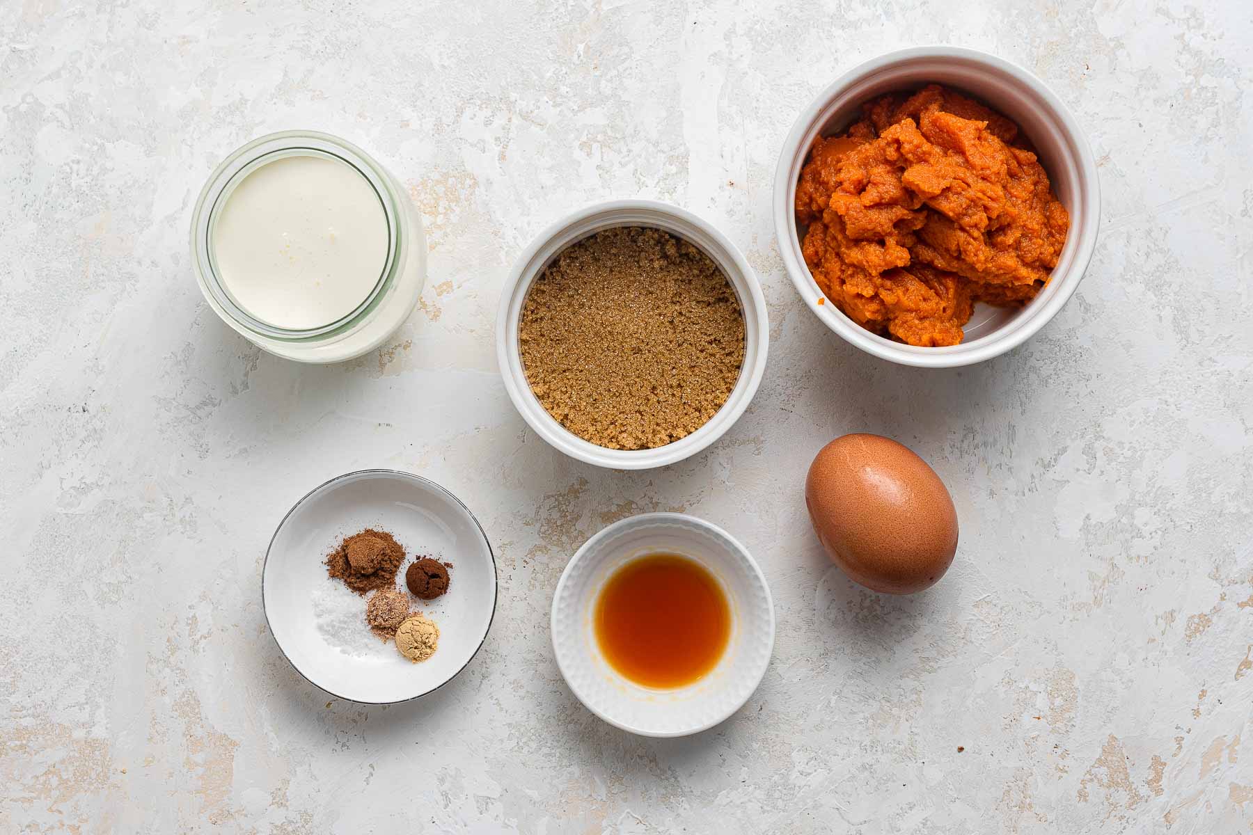 Ingredients for crustless pumpkin pie for two in ramekins.