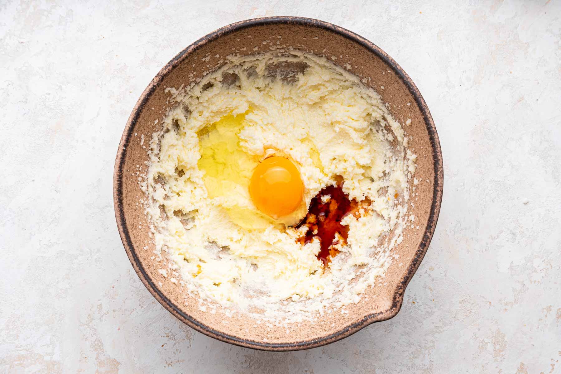 Egg and vanilla extract over pale yellow fluffy cake batter.