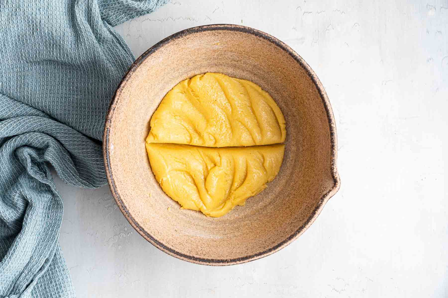 Easy small batch sugar cookies dough in bowl pressed flat.