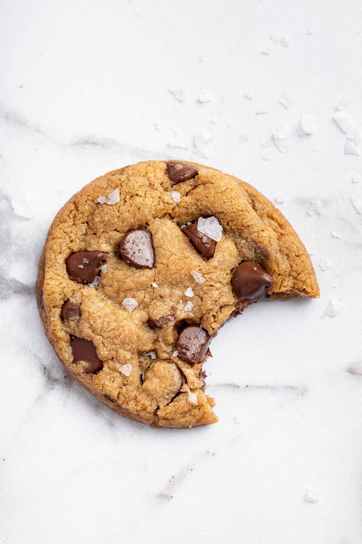 Vertical image of dessert on marble surface with one bite.