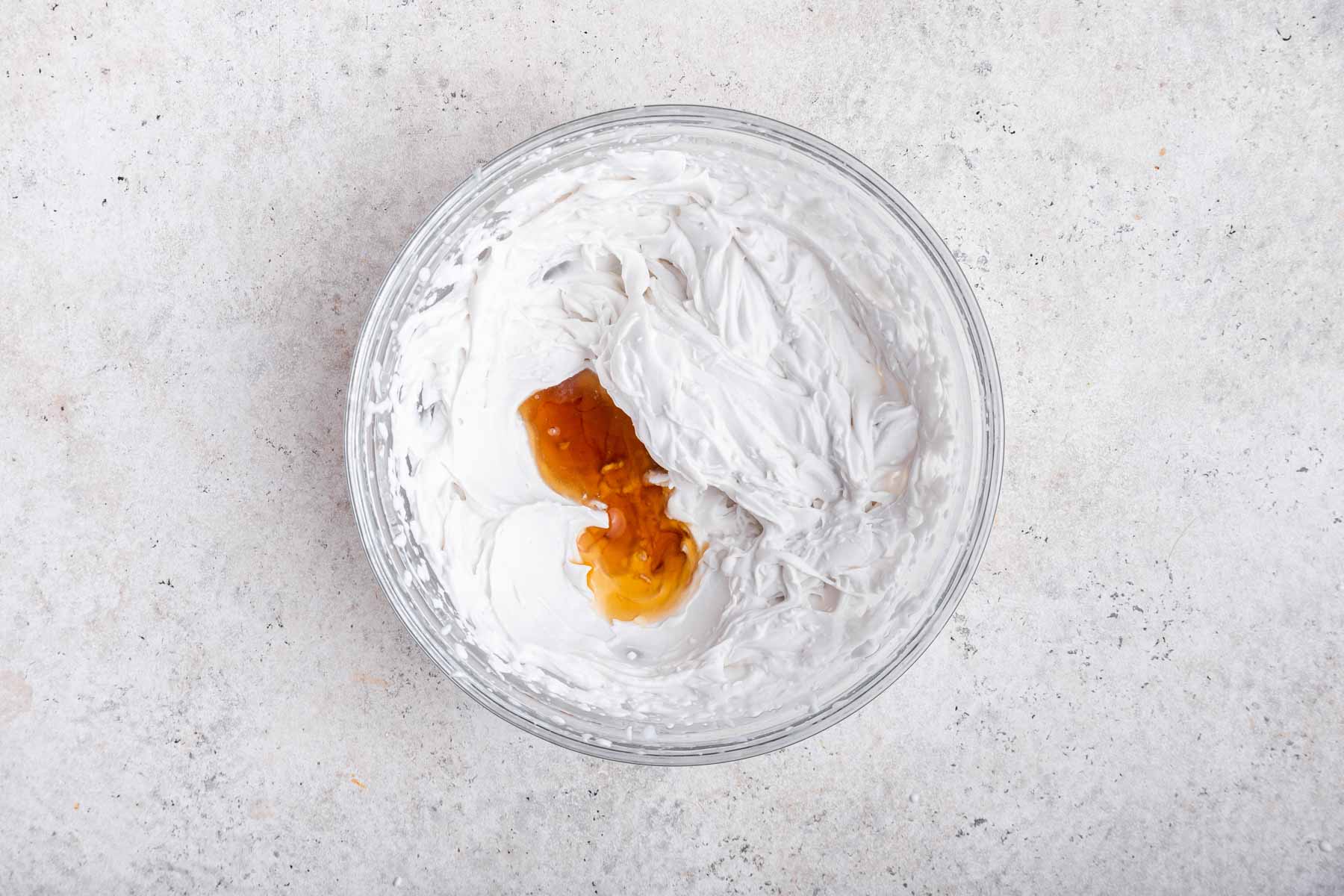 Adding vanilla to freshly beaten coconut cream.