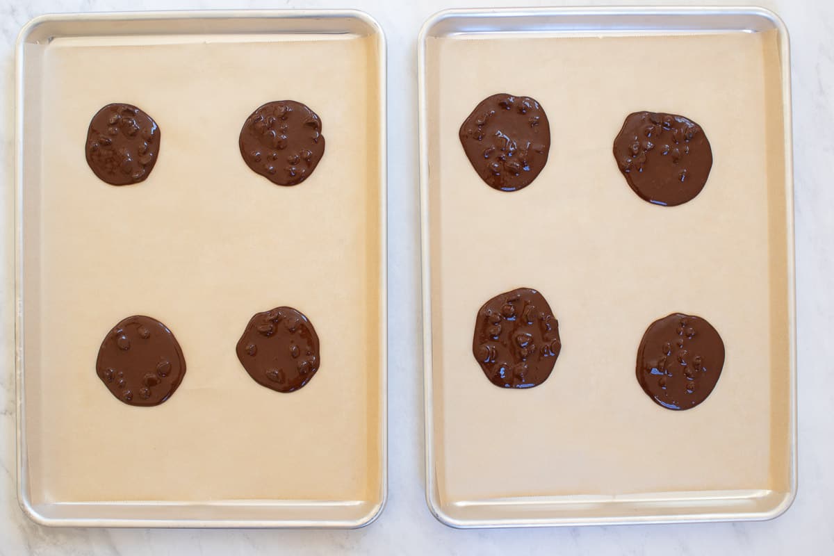 Flourless chocolate cookies on baking sheets, before being baked.