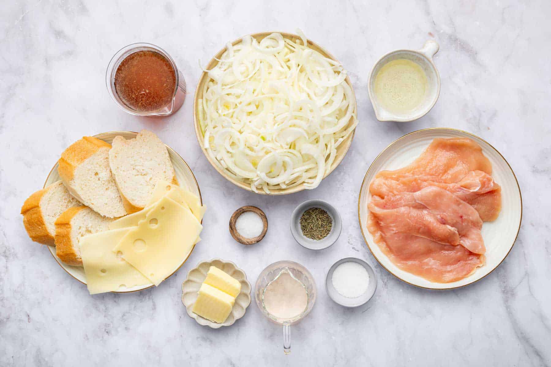 Bowl of thinly sliced vegetables, cutlets, butter, and spices.