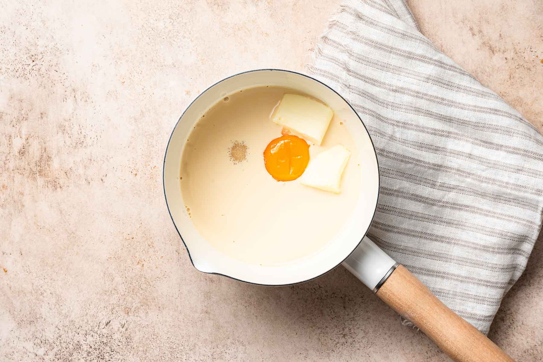 Evaporated milk, egg yolk, and sugar in small saucepan.