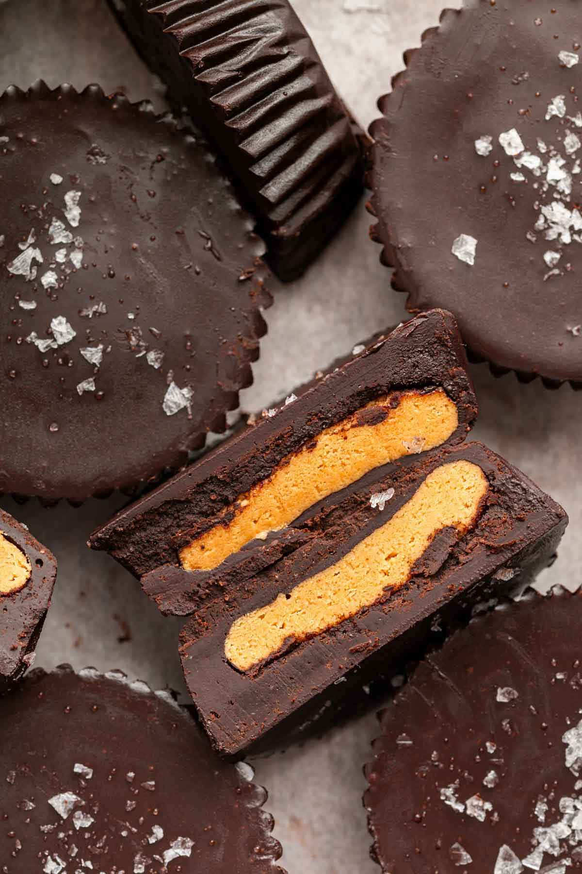Macro image of peanut butter cups cut in half with peanut filling showing.