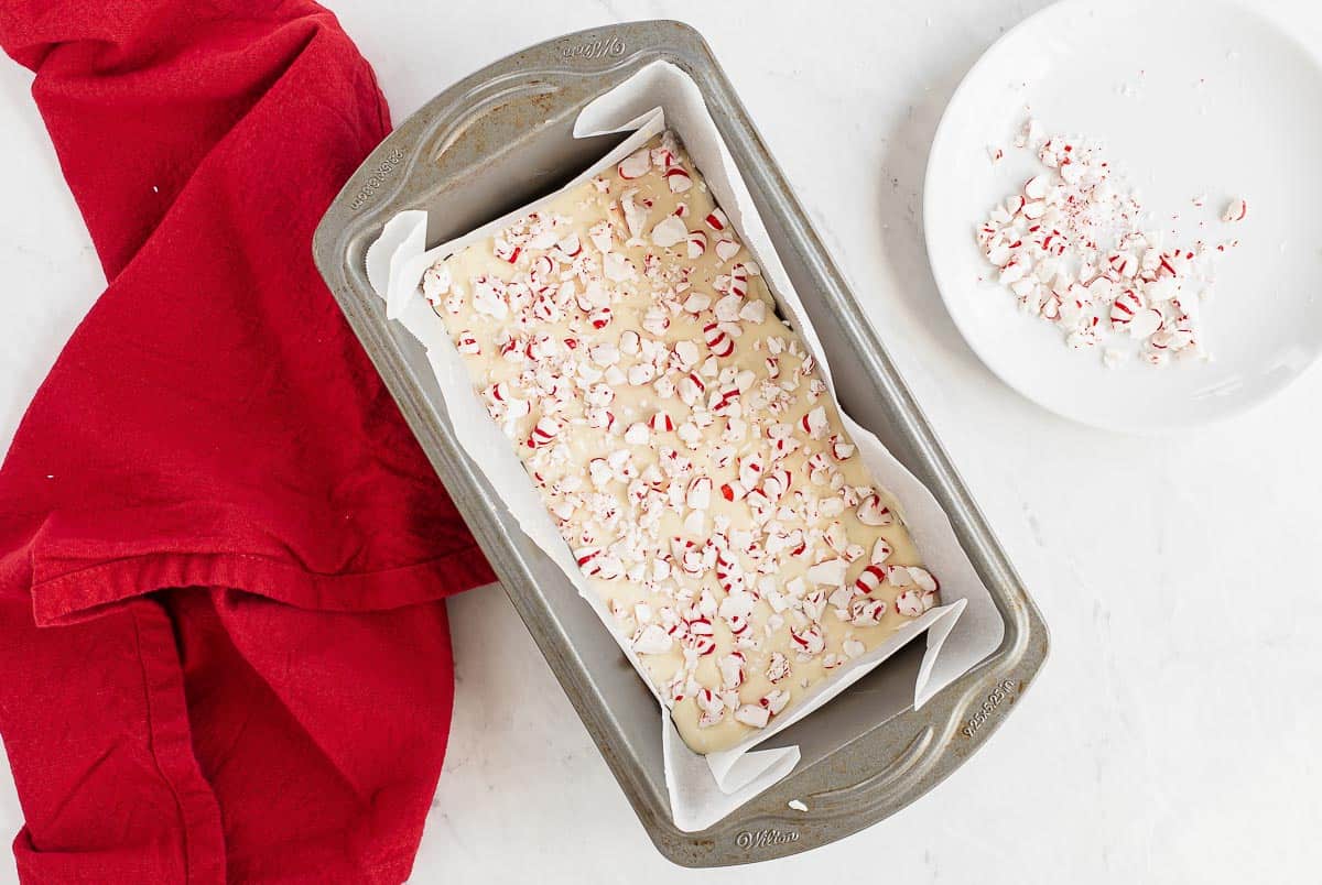 two layers of chocolate with crushed peppermints on top in a pan