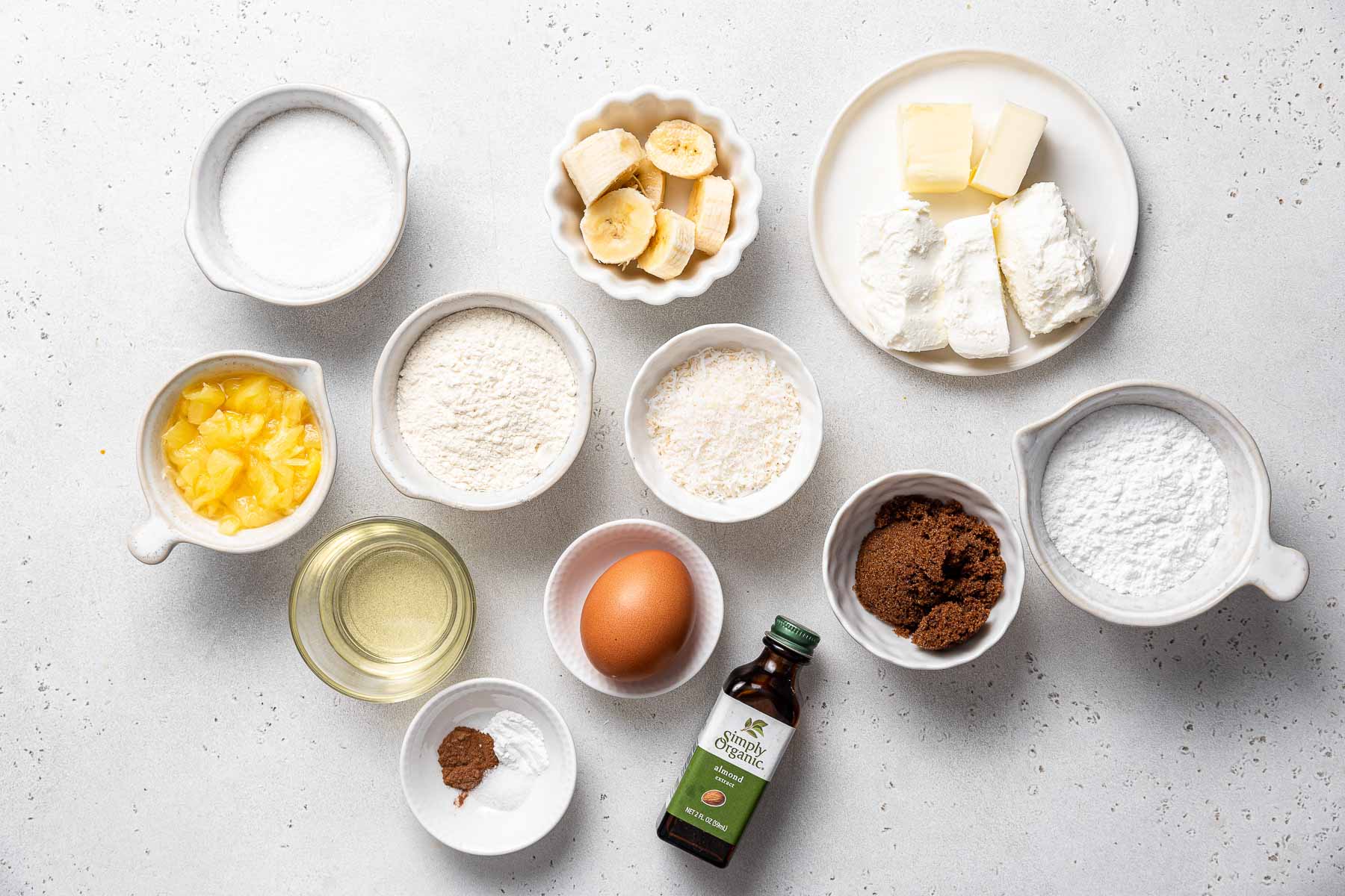 Ingredients for hummingbird cupcakes on white table.