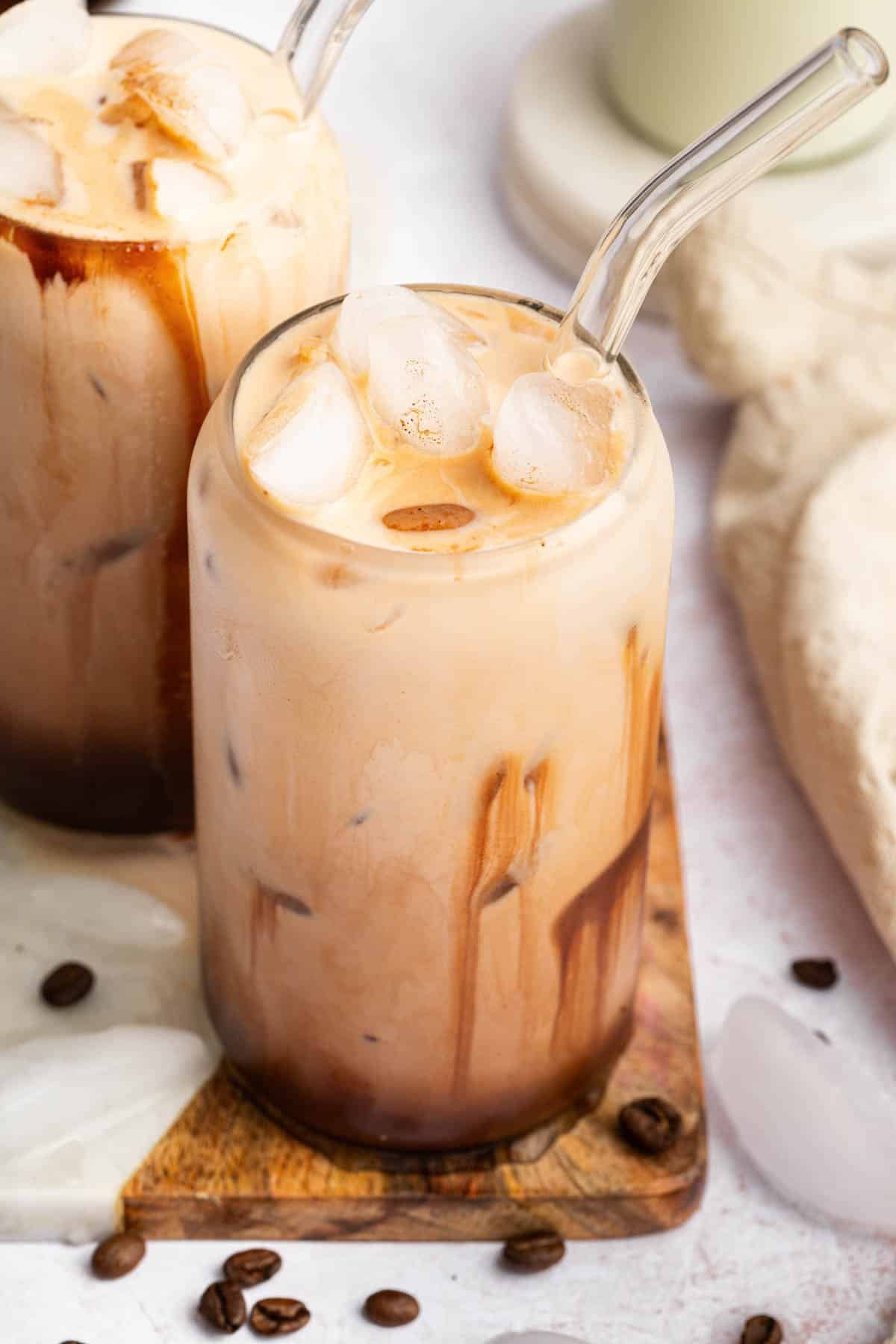 Iced mocha recipe in two glasses with glass straws.
