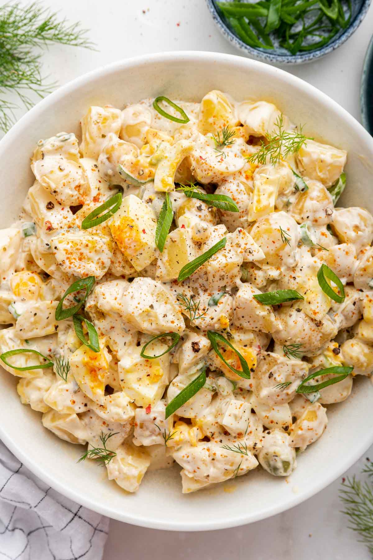 Macro shot of pressure cooker potato salad in white bowl.
